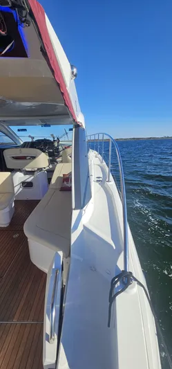 Mambo Italiano Yacht Photos Pics 2015 Beneteau 38 Gran Tourismo yacht on open water, sunny day, side view.