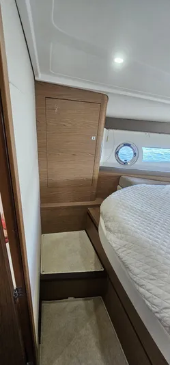 Mambo Italiano Yacht Photos Pics Interior of 2015 Beneteau 38 Gran Tourismo yacht with cozy bed and wooden accents.