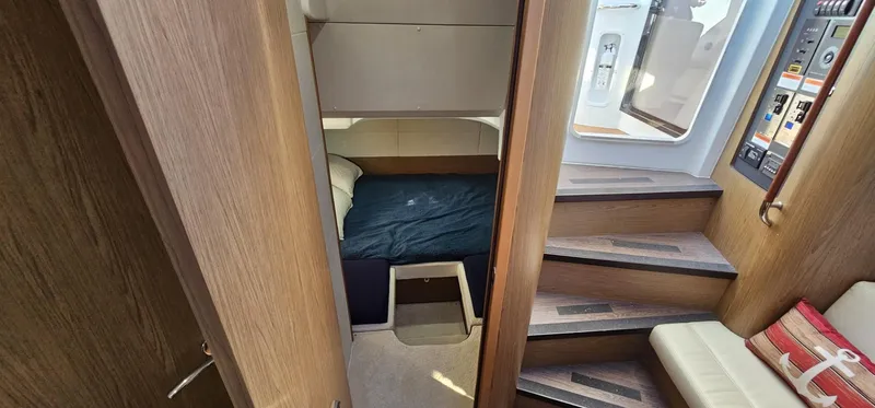 Mambo Italiano Yacht Photos Pics Interior cabin of 2015 Beneteau 38 Gran Tourismo yacht with wooden stairs and cozy bed.