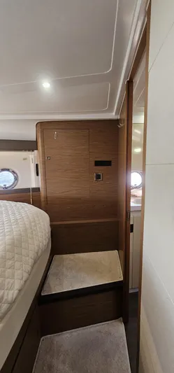 Mambo Italiano Yacht Photos Pics Interior of 2015 Beneteau 38 Gran Tourismo yacht, featuring cozy cabin and wooden finishes.