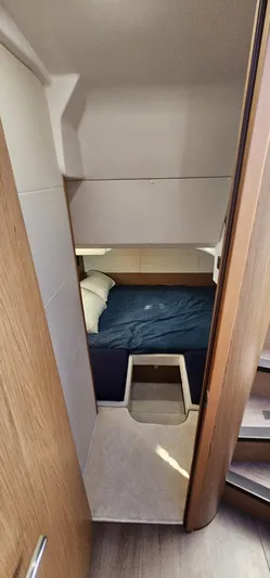 Mambo Italiano Yacht Photos Pics 2015 Beneteau 38 Gran Tourismo cabin interior with bed and wooden accents.