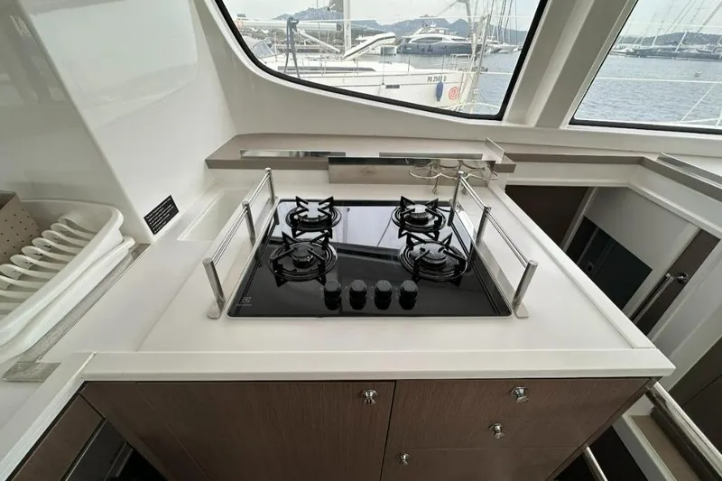  Yacht Photos Pics Modern yacht kitchen with stove, sleek countertops, and ocean view. Bali 4.6, 2021 model.