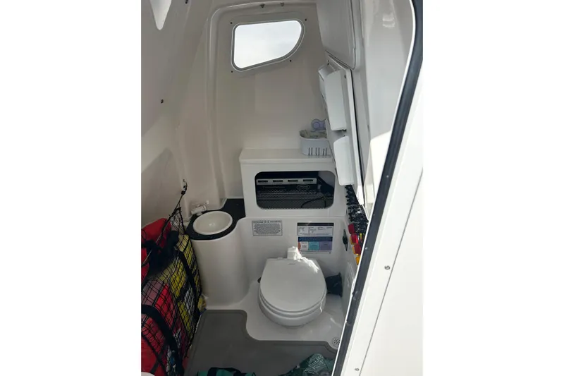  Yacht Photos Pics 2021 Sea Fox 288 Commander boat interior with compact marine toilet and storage.
