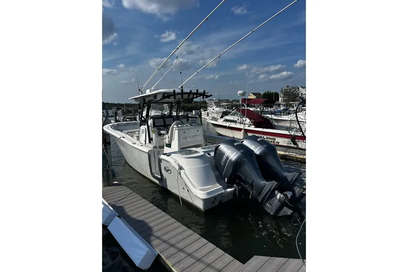  Yacht Photos Pics 2021 Sea Fox 288 Commander boat docked with twin Yamaha engines under a clear sky.