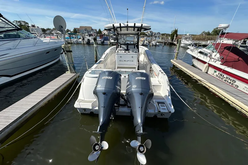  Yacht Photos Pics 2021 Sea Fox 288 Commander boat docked with twin engines, marina background.