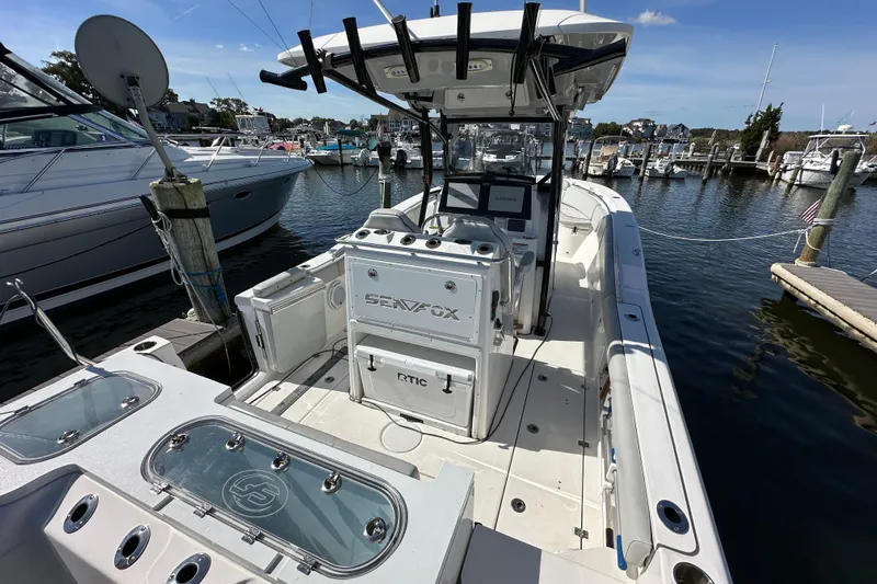  Yacht Photos Pics 2021 Sea Fox 288 Commander boat docked at marina, featuring spacious deck and modern equipment.
