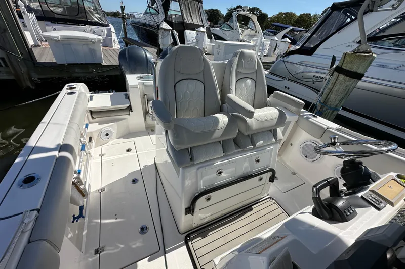  Yacht Photos Pics 2021 Sea Fox 288 Commander boat interior with dual captain's chairs and steering console.