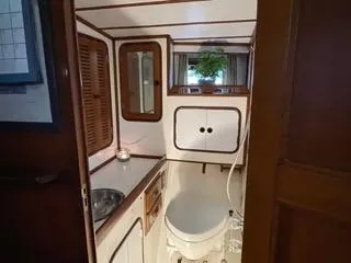  Yacht Photos Pics 1984 Tayana 55 yacht bathroom with sink, toilet, and storage cabinets.