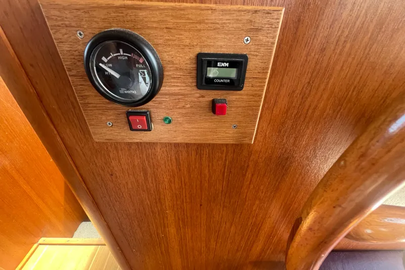 Beryl W Yacht Photos Pics 2001 Mainship 390 Trawler control panel with gauge and switches on wooden surface.