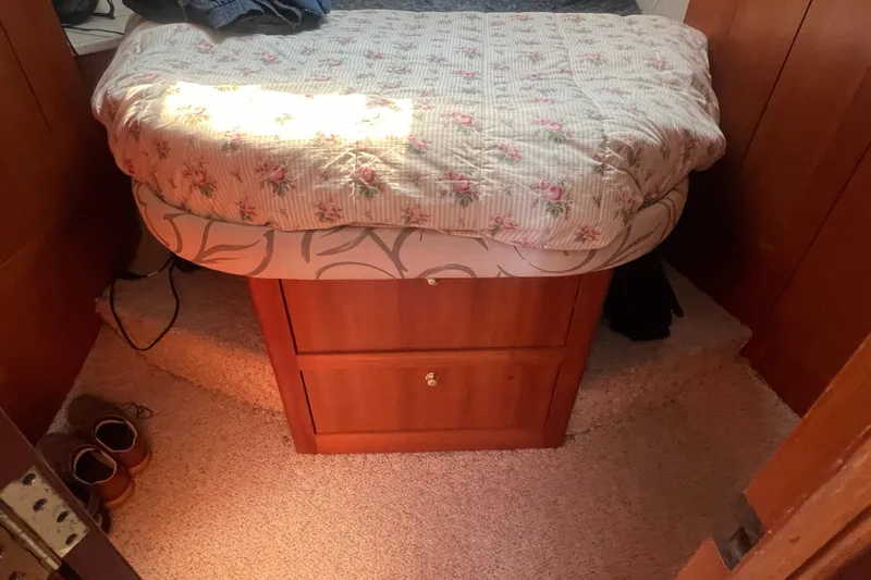 Beryl W Yacht Photos Pics Cozy cabin bedroom in 2001 Mainship 390 Trawler with floral bedding and wooden storage.