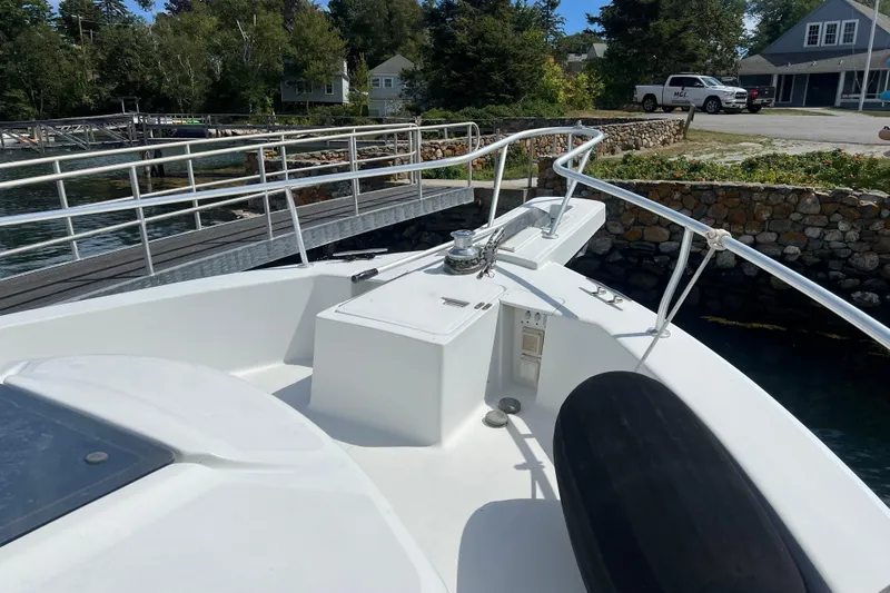 Beryl W Yacht Photos Pics 2001 Mainship 390 Trawler docked, showcasing bow area with railing and winch.