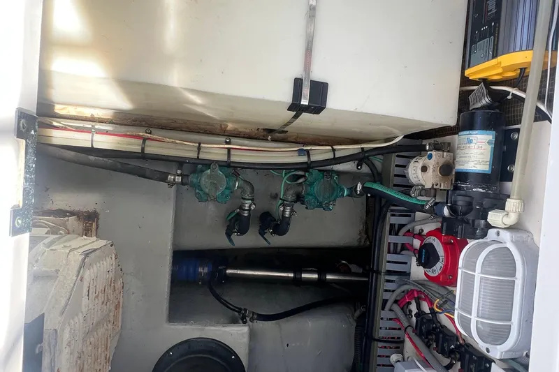 Beryl W Yacht Photos Pics Engine room of a 2001 Mainship 390 Trawler, showcasing mechanical components and wiring.