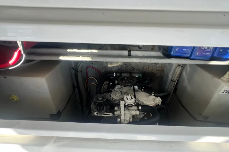 Beryl W Yacht Photos Pics Engine compartment of a 2001 Mainship 390 Trawler, showcasing mechanical components and storage.