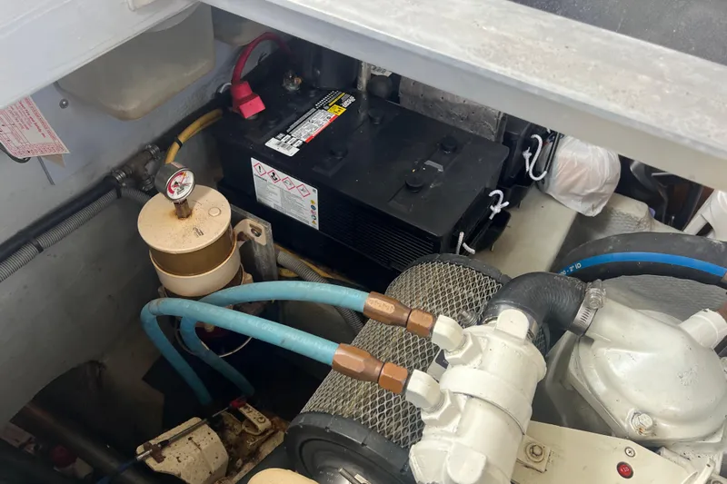 Beryl W Yacht Photos Pics Engine compartment of 2001 Mainship 390 Trawler with battery and fuel filter system.