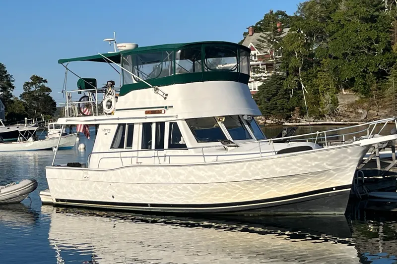 Beryl W Yacht Photos Pics 2001 Mainship 390 Trawler docked in a serene marina setting.