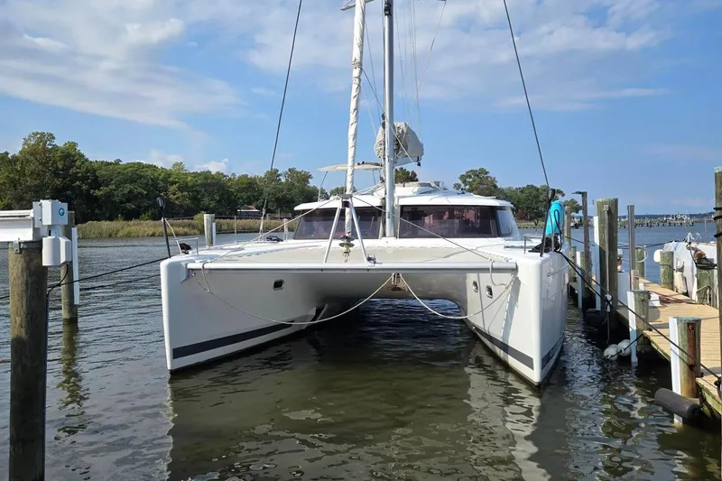 Sweet And Salty Yacht Photos Pics 2018 Fountaine Pajot Helia 44 Evolution catamaran docked in a serene marina setting.