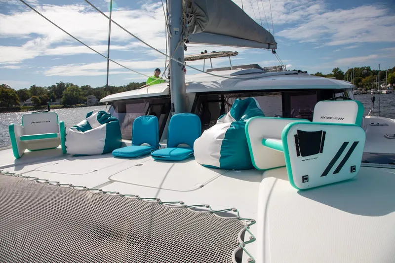 Sweet And Salty Yacht Photos Pics 2018 Fountaine Pajot Helia 44 Evolution catamaran with turquoise seating on deck.
