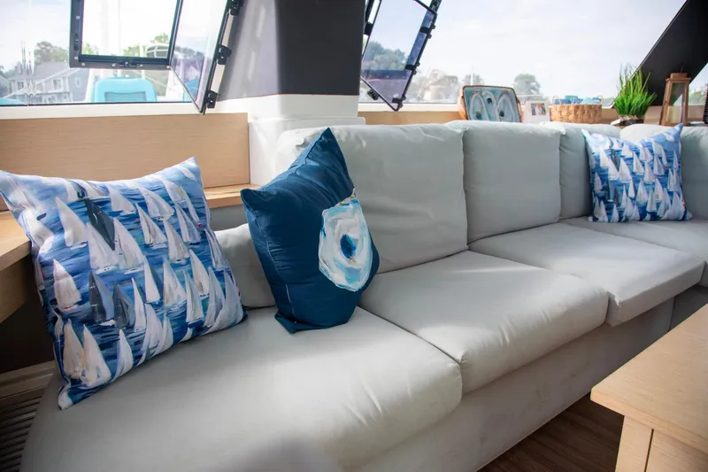 Sweet And Salty Yacht Photos Pics Luxurious interior of 2018 Fountaine Pajot Helia 44 Evolution with nautical-themed cushions.