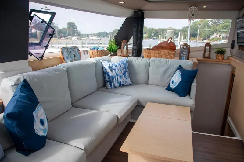 Sweet And Salty Yacht Photos Pics Interior of 2018 Fountaine Pajot Helia 44 Evolution catamaran with cozy seating and nautical decor.