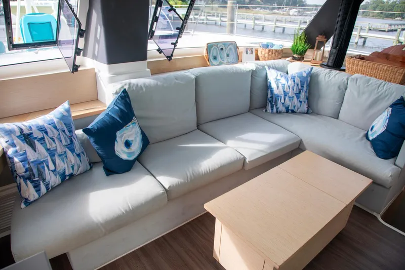 Sweet And Salty Yacht Photos Pics Luxurious interior of 2018 Fountaine Pajot Helia 44 Evolution catamaran with cozy seating and nautical decor.