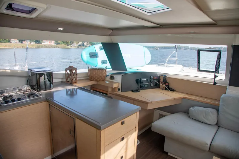 Sweet And Salty Yacht Photos Pics Interior of 2018 Fountaine Pajot Helia 44 Evolution catamaran with modern kitchen and navigation area.