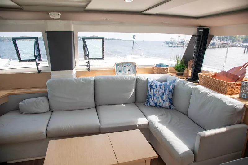 Sweet And Salty Yacht Photos Pics Luxurious interior of 2018 Fountaine Pajot Helia 44 Evolution catamaran with comfortable seating and ocean view.