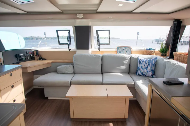 Sweet And Salty Yacht Photos Pics Interior of 2018 Fountaine Pajot Helia 44 Evolution catamaran with cozy seating and ocean view.