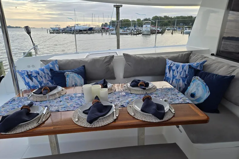 Sweet And Salty Yacht Photos Pics Luxurious dining setup on 2018 Fountaine Pajot Helia 44 Evolution yacht, overlooking marina.
