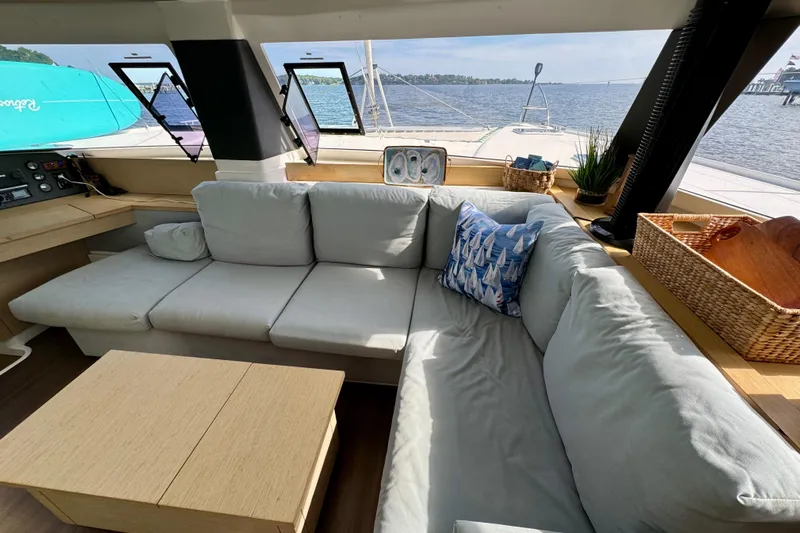 Sweet And Salty Yacht Photos Pics Luxurious interior of 2018 Fountaine Pajot Helia 44 Evolution catamaran with comfortable seating and scenic views.