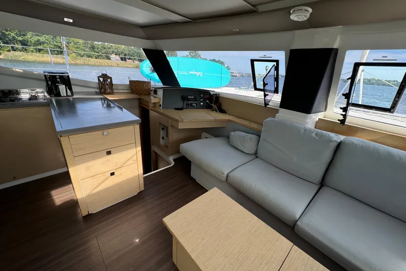 Sweet And Salty Yacht Photos Pics Interior of 2018 Fountaine Pajot Helia 44 Evolution catamaran with modern kitchen and seating area.