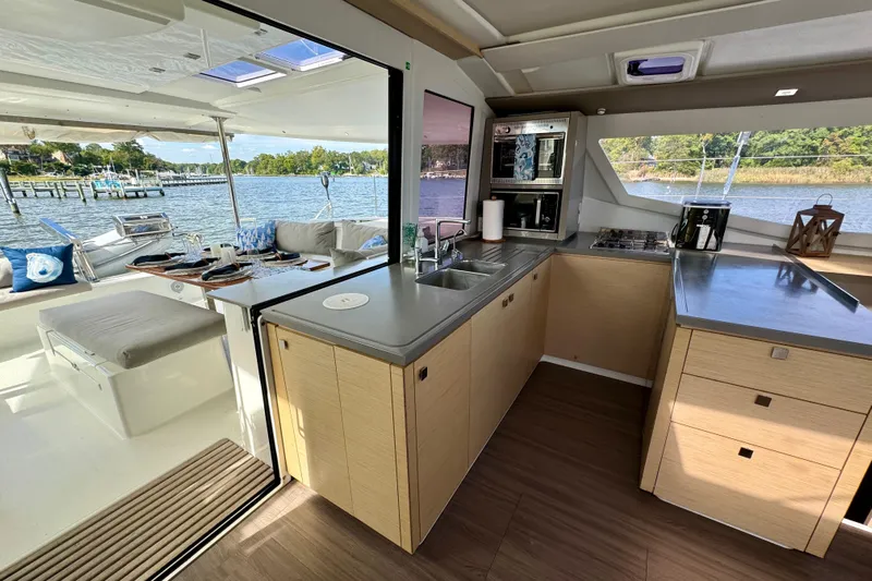 Sweet And Salty Yacht Photos Pics Modern kitchen and dining area on 2018 Fountaine Pajot Helia 44 Evolution yacht.