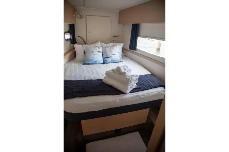 Sweet And Salty Yacht Photos Pics Cozy cabin interior of 2018 Fountaine Pajot Helia 44 Evolution with neatly arranged bed and towels.