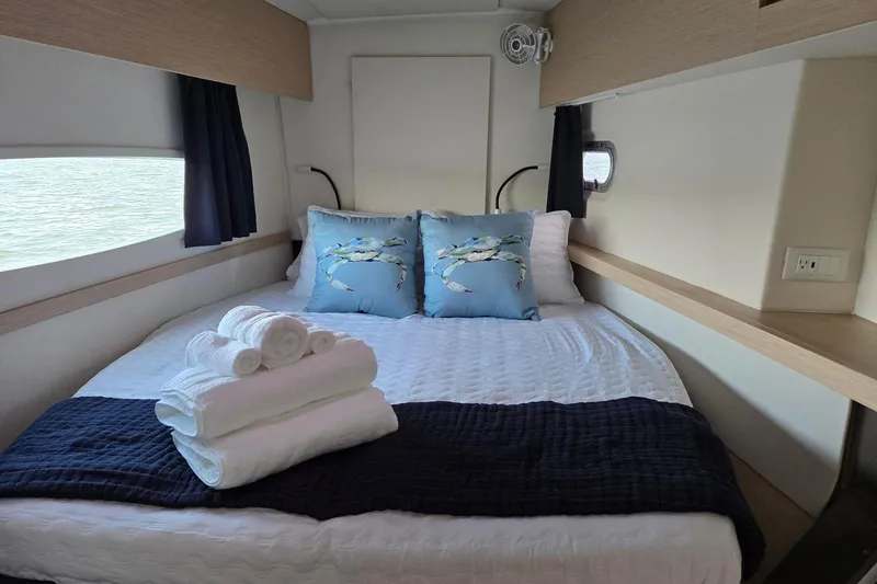 Sweet And Salty Yacht Photos Pics Cozy cabin interior of 2018 Fountaine Pajot Helia 44 Evolution with neatly arranged bed linens.