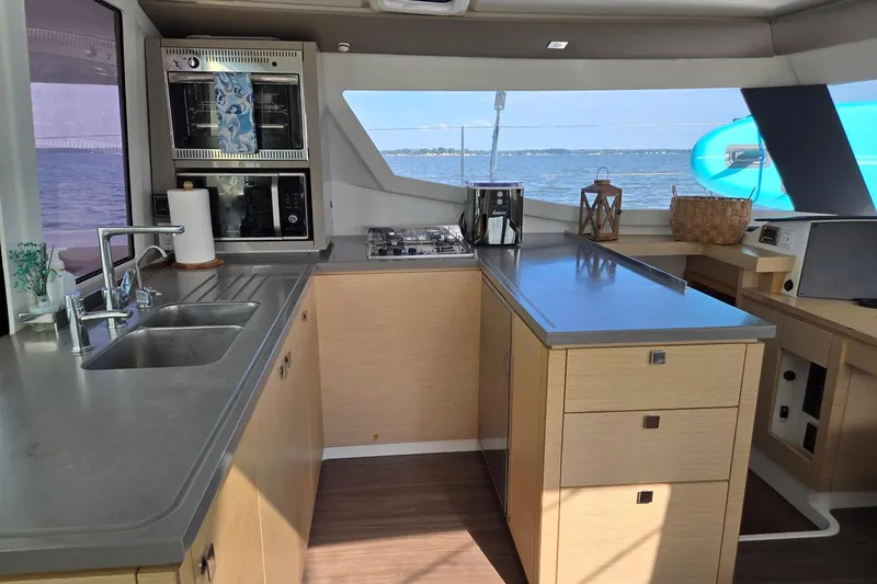 Sweet And Salty Yacht Photos Pics Modern kitchen interior of 2018 Fountaine Pajot Helia 44 Evolution catamaran with ocean view.