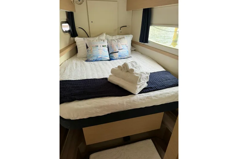 Sweet And Salty Yacht Photos Pics Cozy cabin interior of 2018 Fountaine Pajot Helia 44 Evolution with neatly arranged bed linens.