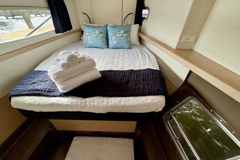 Sweet And Salty Yacht Photos Pics Cabin interior of 2018 Fountaine Pajot Helia 44 Evolution with bed and nautical decor.