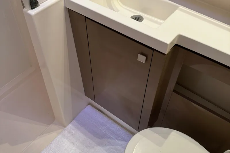 Sweet And Salty Yacht Photos Pics Bathroom interior of 2018 Fountaine Pajot Helia 44 Evolution yacht, featuring modern sink and cabinetry.
