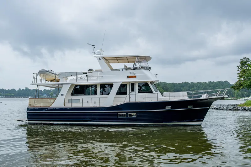 Venture Yacht Photos Pics 2014 Grand Banks 54 Europa yacht on calm water under cloudy skies.