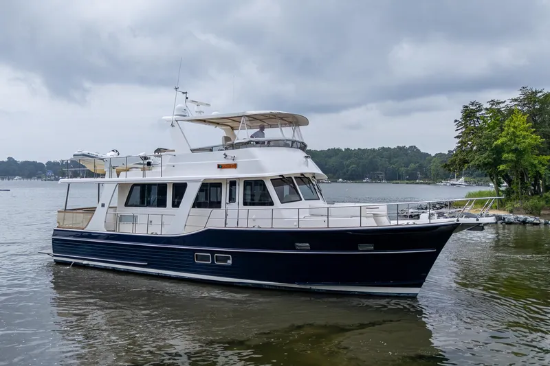 Venture Yacht Photos Pics 2014 Grand Banks 54 Europa yacht on a calm lake under cloudy skies.