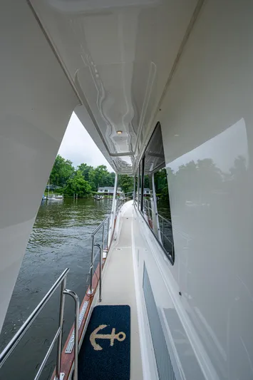 Venture Yacht Photos Pics Side deck view of 2014 Grand Banks 54 Europa yacht, featuring sleek design and water backdrop.