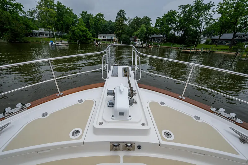 Venture Yacht Photos Pics Bow view of 2014 Grand Banks 54 Europa yacht on a serene river.