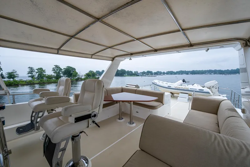 Venture Yacht Photos Pics Luxurious 2014 Grand Banks 54 Europa yacht interior with seating and scenic water view.