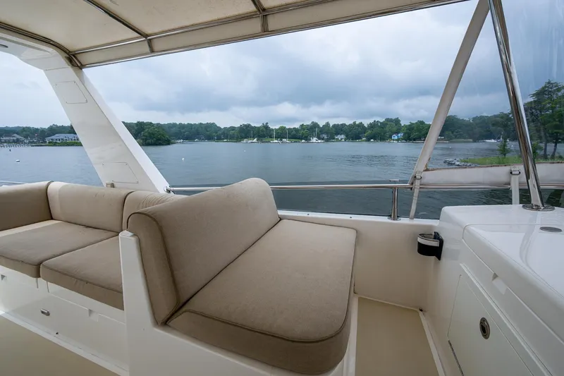 Venture Yacht Photos Pics Luxurious seating on 2014 Grand Banks 54 Europa yacht overlooking serene waters.