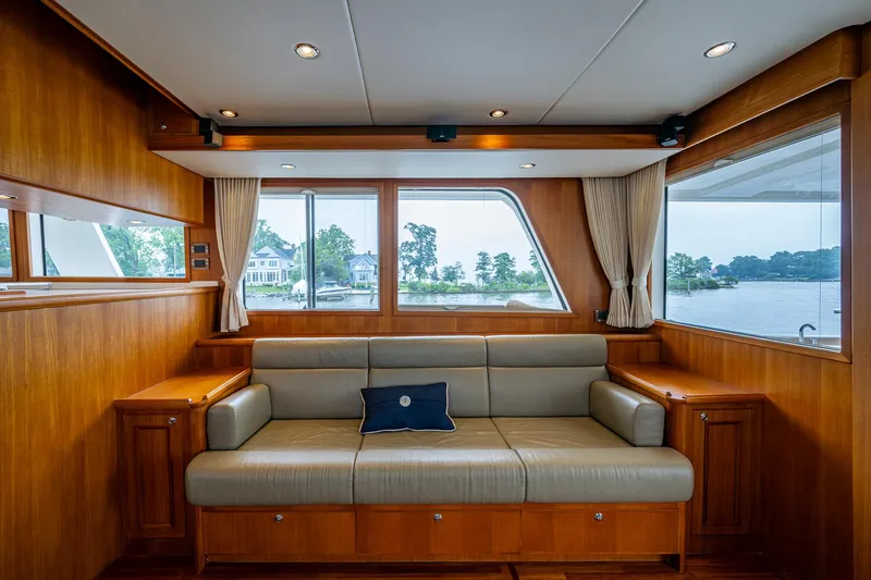 Venture Yacht Photos Pics Luxurious interior of 2014 Grand Banks 54 Europa yacht with elegant seating and scenic window views.