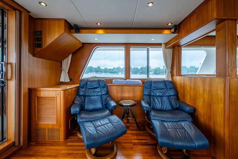 Venture Yacht Photos Pics Luxurious interior of 2014 Grand Banks 54 Europa yacht with leather recliners and wood paneling.
