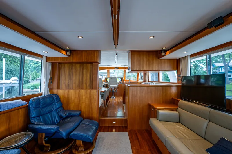 Venture Yacht Photos Pics Luxurious interior of 2014 Grand Banks 54 Europa yacht with wood paneling and comfortable seating.
