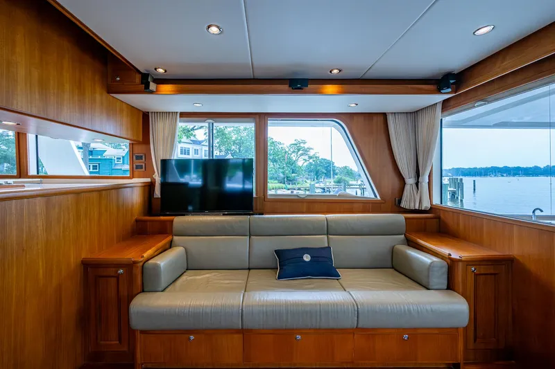 Venture Yacht Photos Pics Luxurious interior of 2014 Grand Banks 54 Europa yacht with sofa and scenic window view.