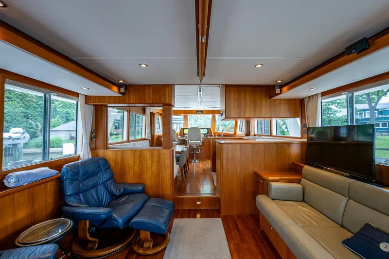 Venture Yacht Photos Pics Luxurious interior of 2014 Grand Banks 54 Europa yacht with wood paneling and comfortable seating.