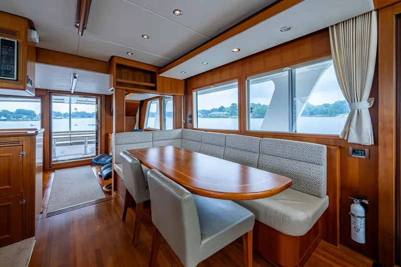 Venture Yacht Photos Pics Luxurious interior of 2014 Grand Banks 54 Europa yacht with elegant dining area and scenic windows.