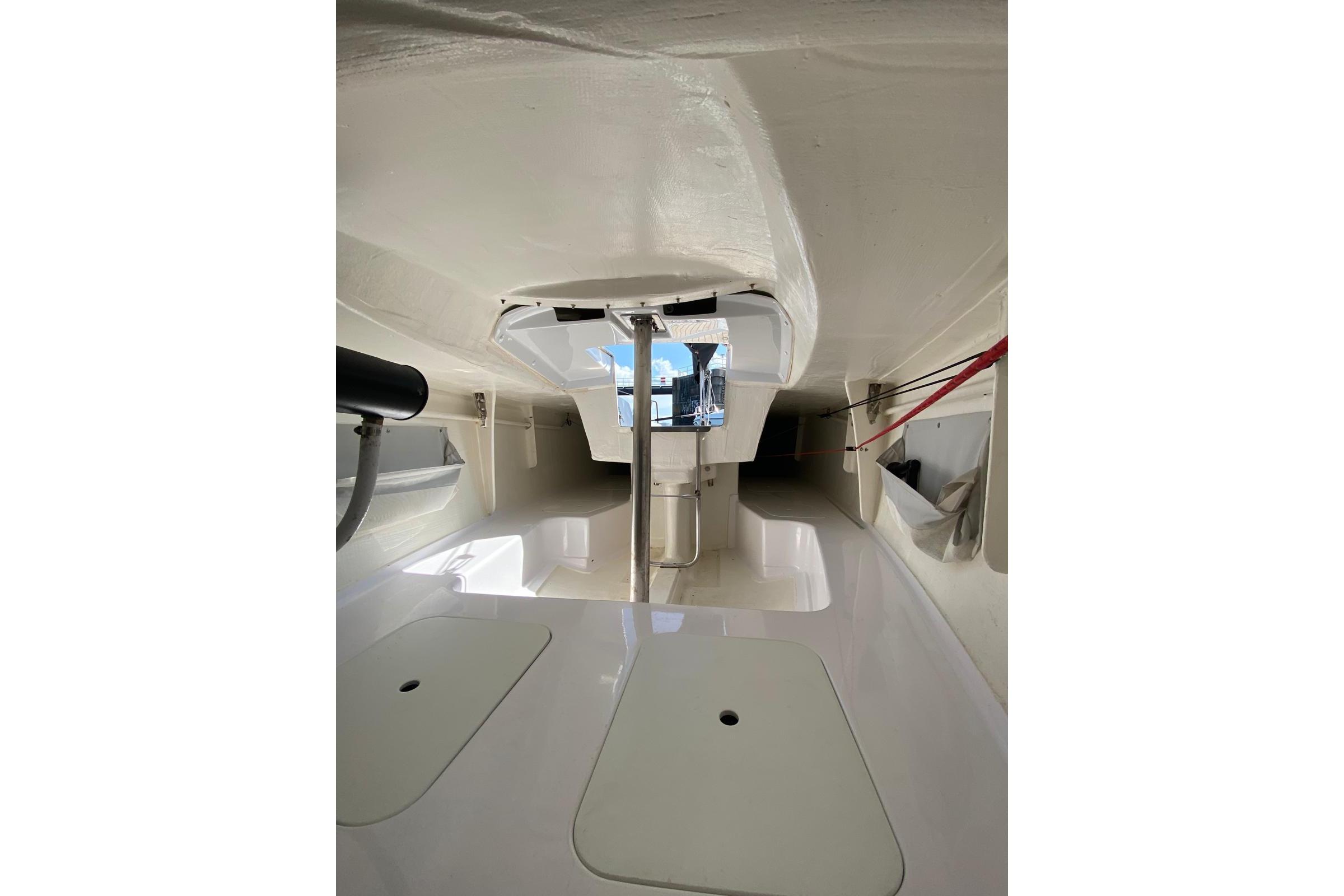 Interior view of 2020 Esse 850 LE sailboat, showcasing sleek white design and spacious layout.